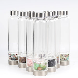Introducing the Water Harmonizing Natural Crystal Water Bottle, an exquisite fusion of functionality and natural beauty. Manifestation crystal water bottle. BPA free. Multi colored crystal infused water bottle 
